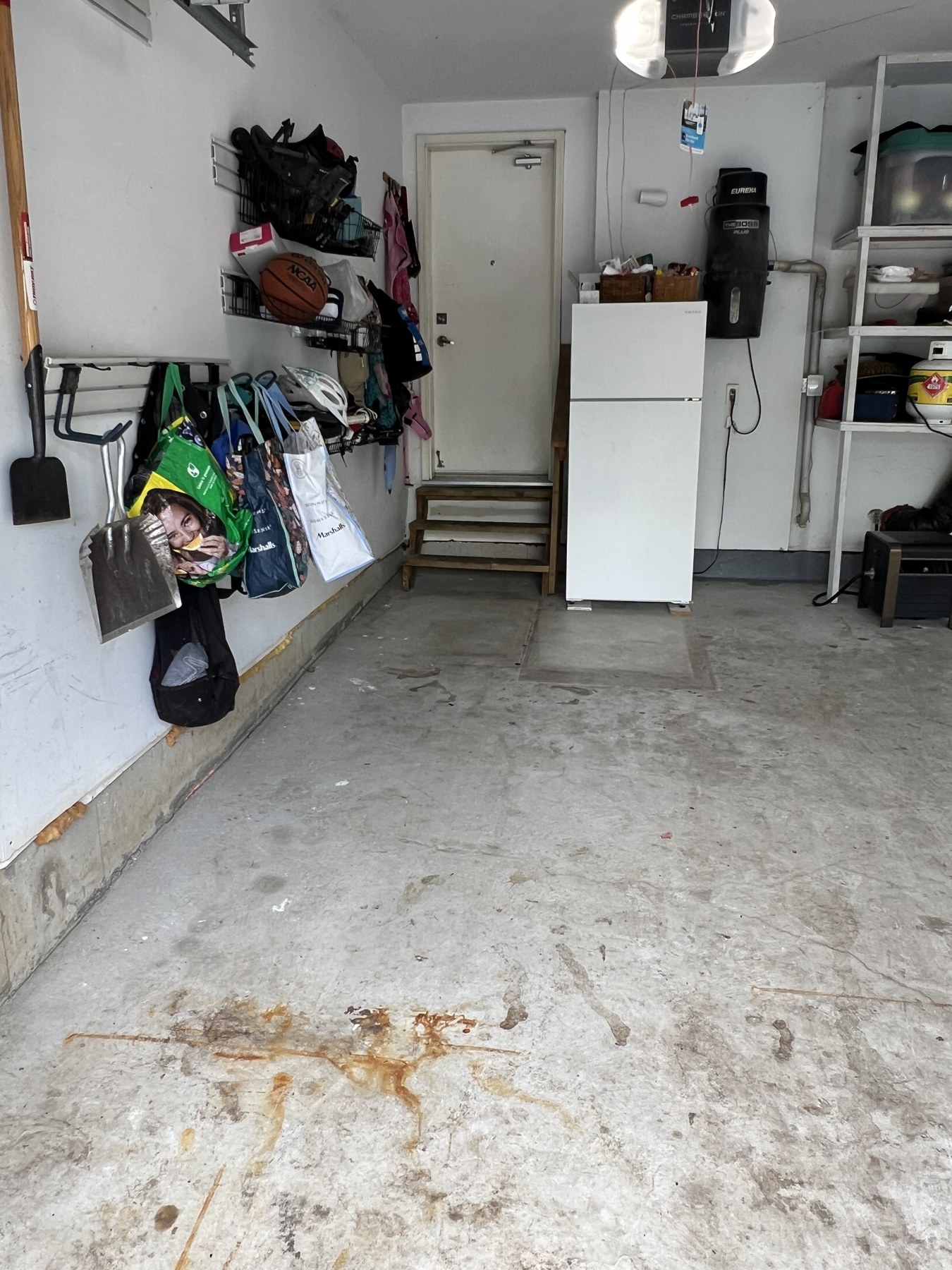 Stained bare concrete garage floor before coating