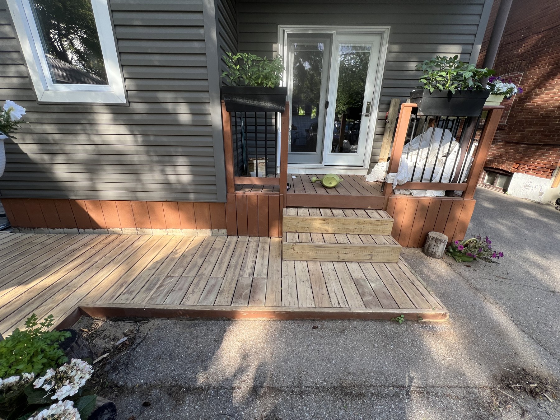 Weathered deck steps by patio doors before staining